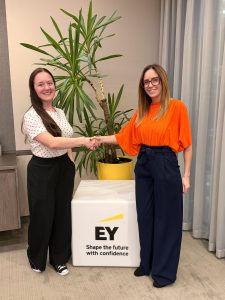 Nicola Williams shaking hands with EY Foundation employee for partnership