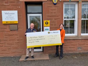 NFU Mutual presenting a donation cheque of £7,899 to The Mark Williams Foundation outside their office